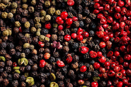 A mixture of unripe and ripe black peppercorns